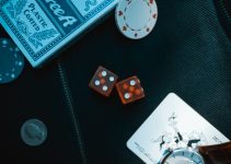 two orange dice on black surface