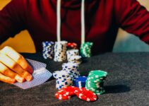 person sitting near poker chips