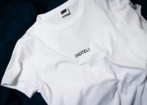 white hotel-printed crew-neck shirt on black surface