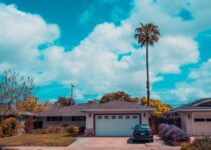 white and gray house with closed garage door