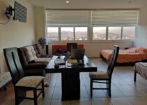 black laptop computer on brown wooden table