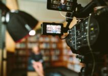 person sitting in front bookshelf