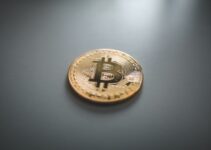 gold round coin on gray surface