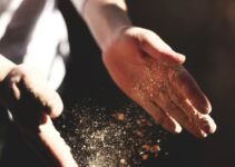 person's hand with dust during daytime