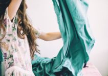 woman holding green textile inside room