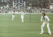 man in white polo shirt and white pants holding golf club