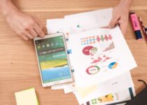 person holding white Samsung Galaxy Tab