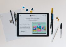 a white tablet with a few pens and a few pencils