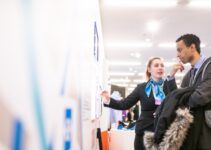 man and woman talking near the wall