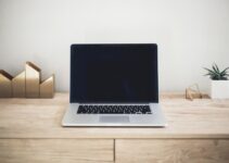 MacBook Pro on top of brown table