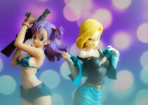 woman in black tank top holding yellow haired male anime character