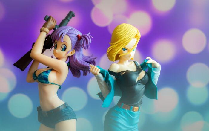 woman in black tank top holding yellow haired male anime character