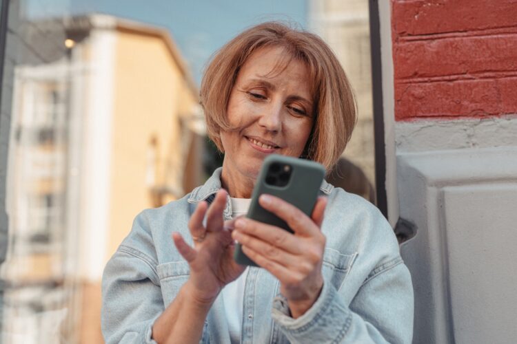 Woman Wearing Denim Jacket Using a Cellphone