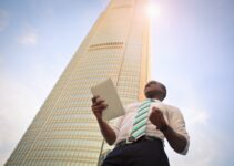 man standing near high-rise building