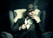 a man sitting in a chair smoking a cigarette