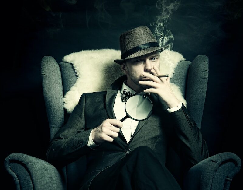 a man sitting in a chair smoking a cigarette