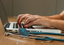 A healthcare professional doing work on their laptop