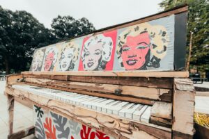 white and red graffiti on brown wooden fence