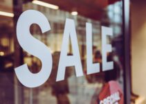 a close up of a sale sign in a store window