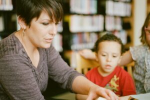 a woman and a boy in a library