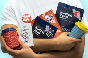 a man holding a cup of coffee and some snacks