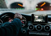 person inside vehicle holding steering wheel