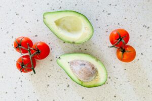 Avocado and tomatoes on a counter top