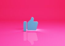 a thumbs up sign on a pink background