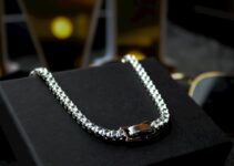 A black box with a silver chain on it