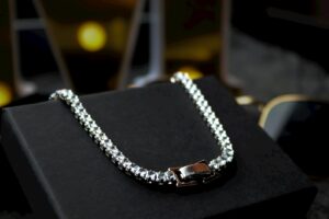 A black box with a silver chain on it