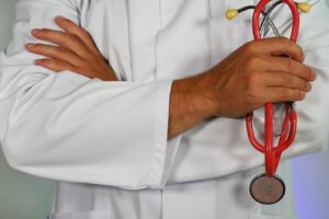 doctor holding red stethoscope