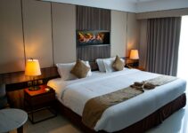 white bed linen with throw pillows