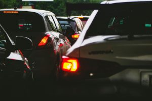 A close-up view of a traffic jam showcasing rear car lights glowing at dusk.