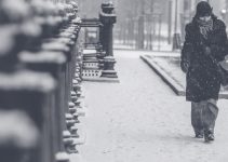 grayscale photo of person walking on street