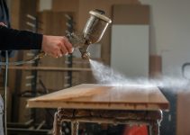a person using a grinder on a wooden table