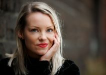 a woman with her hand on her face