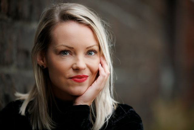 a woman with her hand on her face