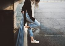 woman standing beside fence