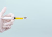 person holding yellow and white pen