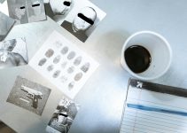 Flat lay of forensic evidence and police investigation documents on a desk.