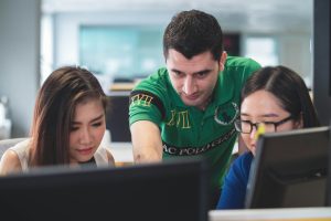 two women and one man on computer screen