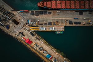 An aerial view of a cargo ship docked at a dock