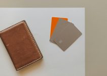 A leather wallet and credit cards on a minimalist background, ideal for financial themes.