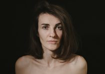 a woman with no shirt posing for a picture