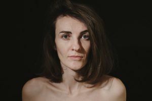 a woman with no shirt posing for a picture