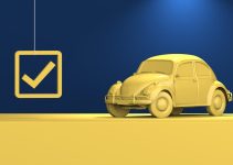 a yellow car parked in front of a blue wall