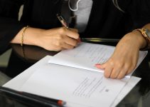 a person writing on a piece of paper