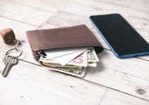 black leather bifold wallet on white table