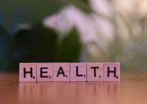 A wooden block spelling the word health on a table