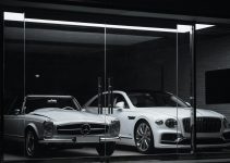 A vintage Mercedes-Benz and a modern Bentley parked behind a glass storefront